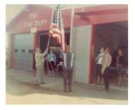 A flag raising ceremony when they built onto the station by adding an additional bay for the “New” 1969 Ford truck in front of our original fire station located at its current site 207 N. Second Street.